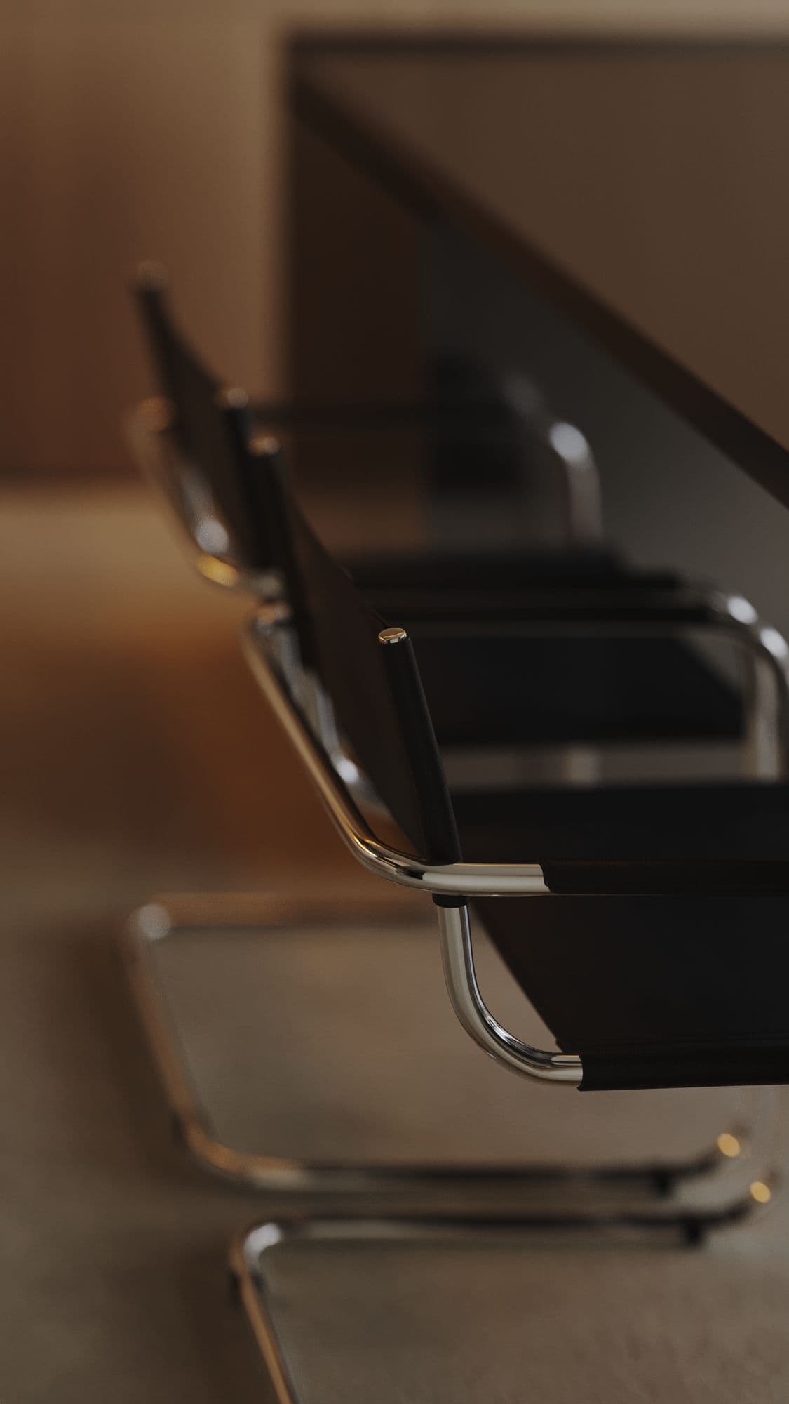 Row of modern black leather cantilever chairs with chrome frames beside a dark, minimalist table.